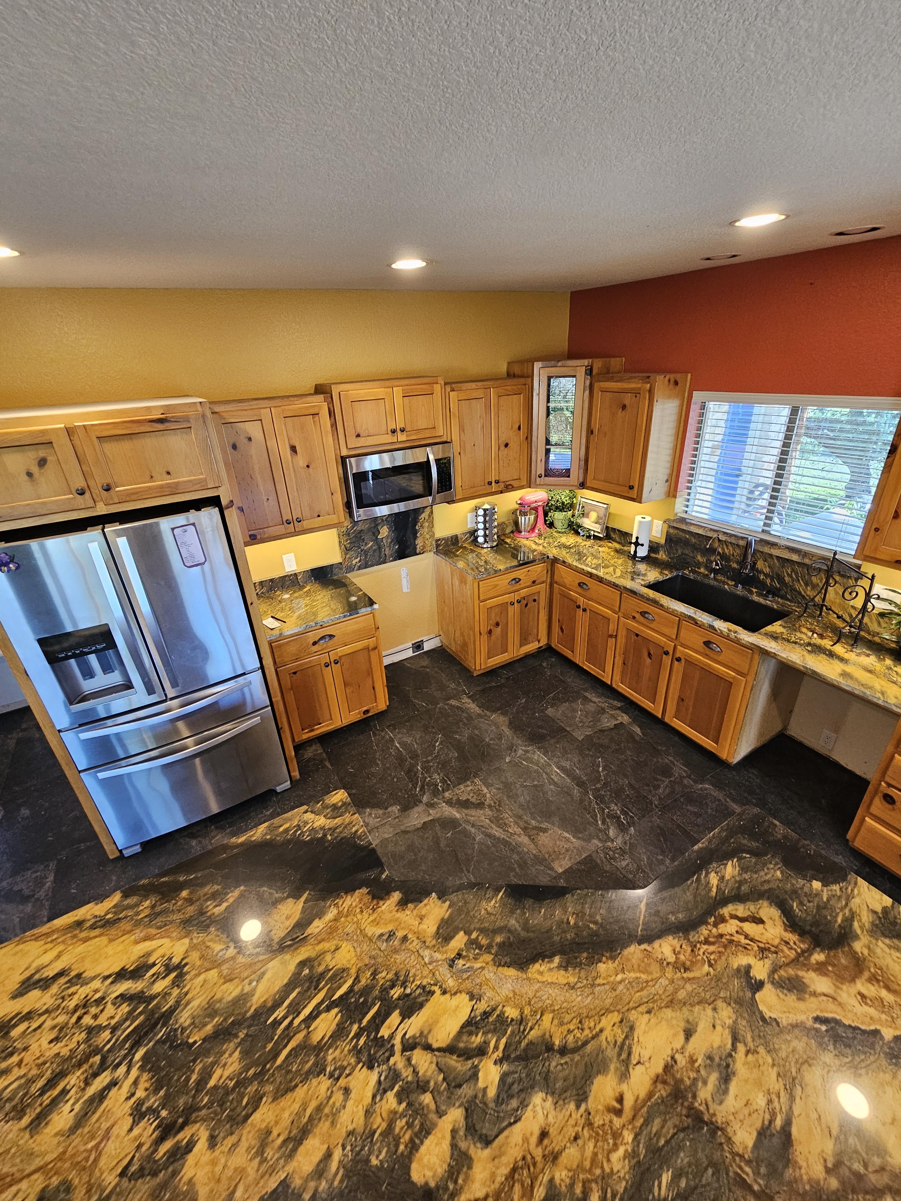 Overview of dark stone-look kitchen floor tile from above the kitchen counters.